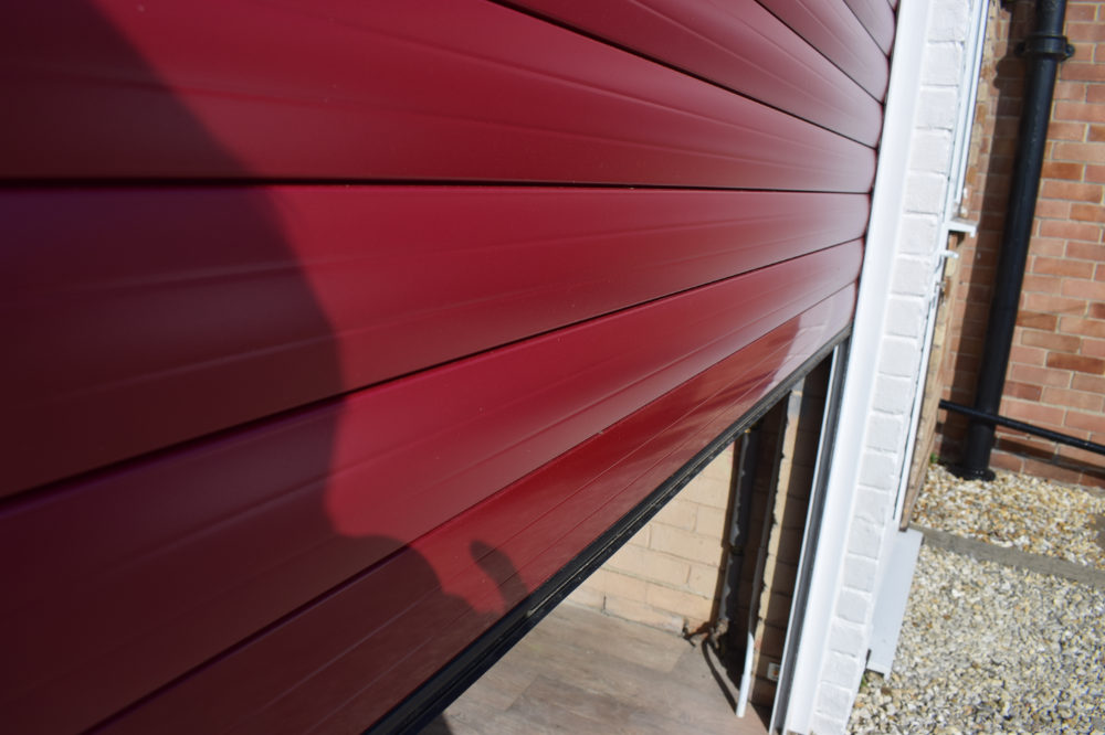 Red roller shutter garage door close up