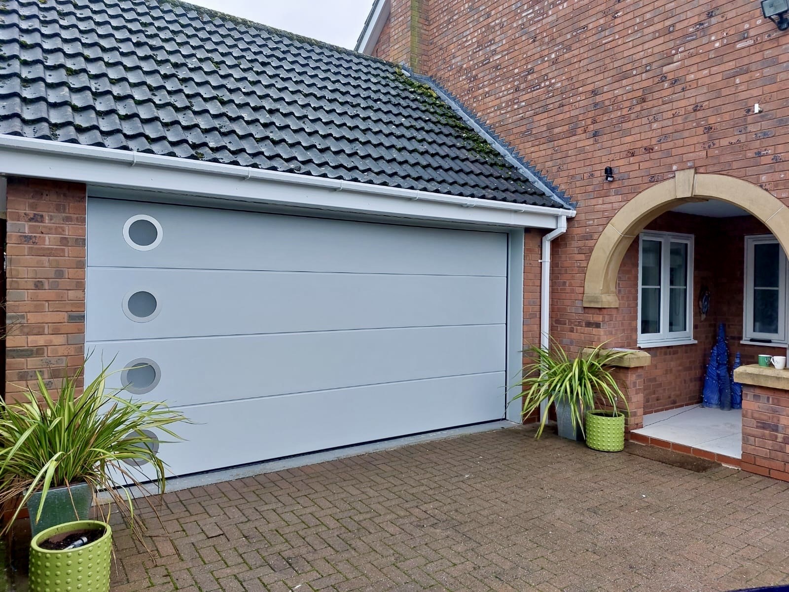 White double garage to the left of the property