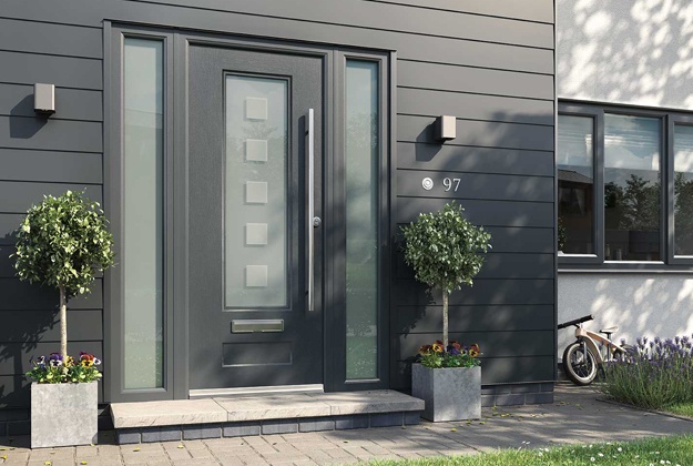 Grey composite front door with trees both sides