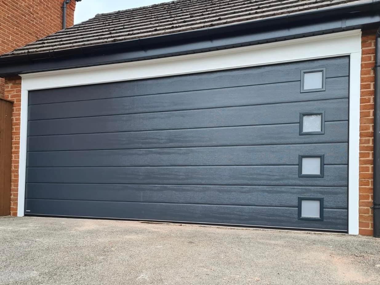 Grey double garage door with square windows